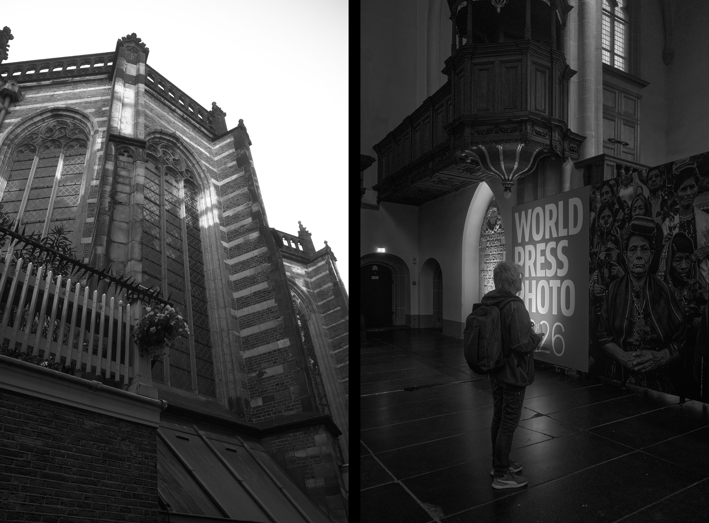 A person stands facing a wall with a black and white poster labeled World Press Photo. Arched doorways and a patterned brick wall are visible behind them.